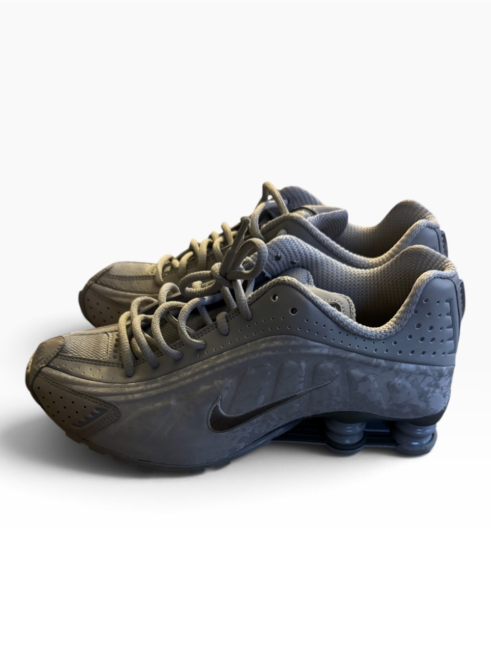 grey Nike Shox R4 sneakers featuring the signature columnar cushioning springs